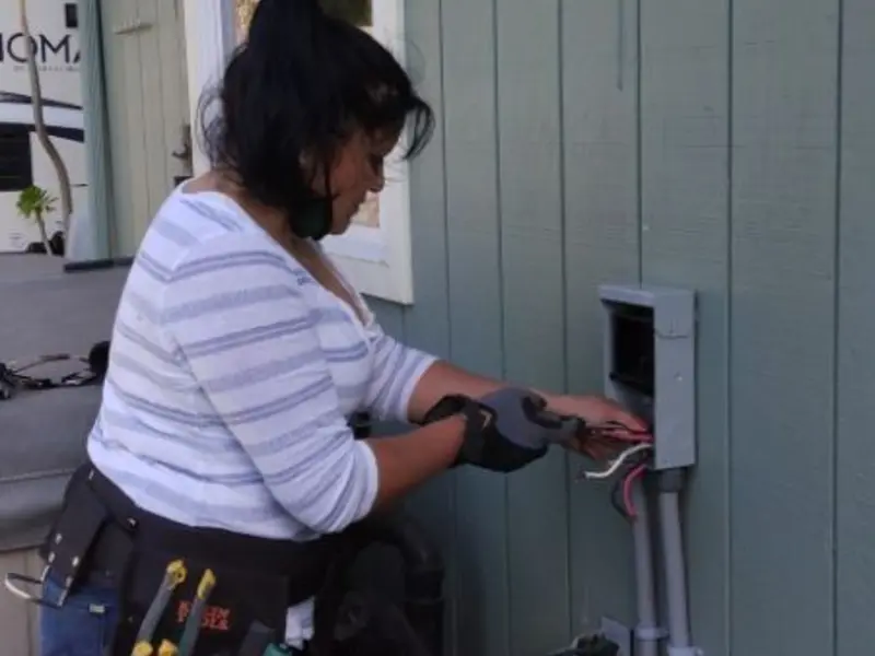 Licensed electrician wiring an exterior subpanel in Fort Rucker