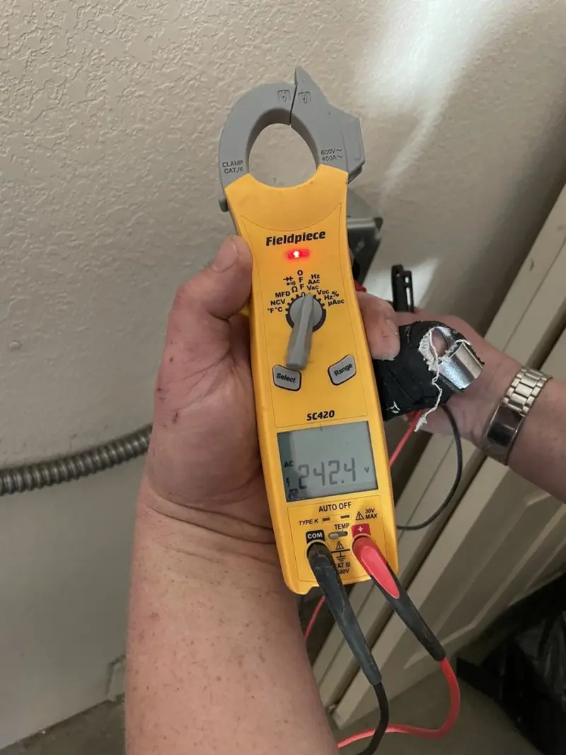 Voltage testing with clamp meter during Ceiling Fan Installation in Fort Rucker